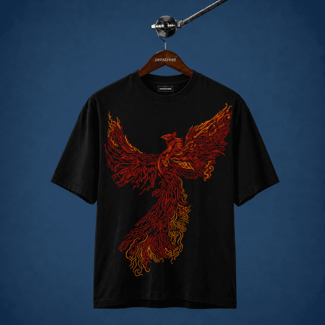 A black short-sleeve t-shirt hanging on a wooden hanger labeled 'zenstreet', featuring a large fiery phoenix graphic in red, orange, and yellow on the front, set against a dark blue background.